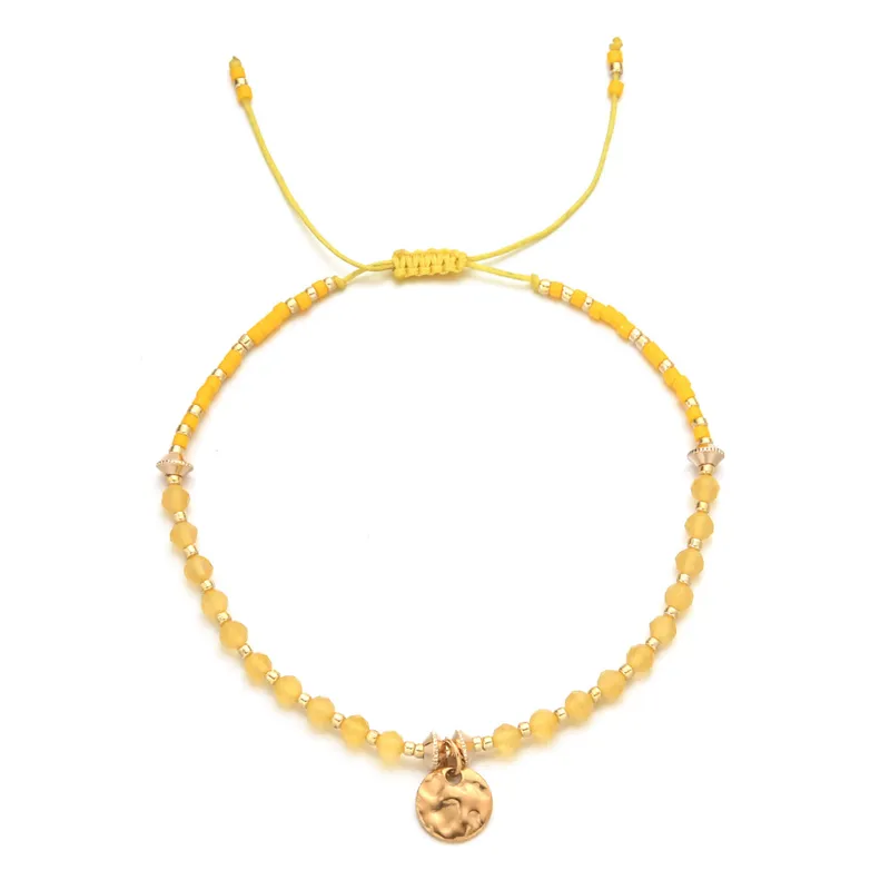 18ct gold plated disc with gemstones