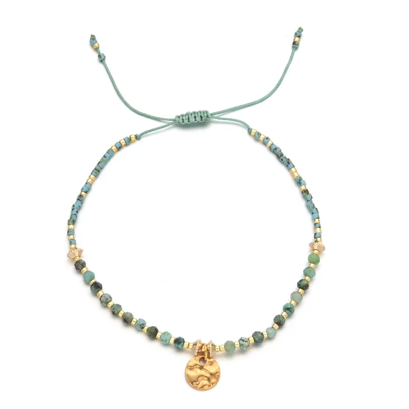 18ct gold plated disc with gemstones