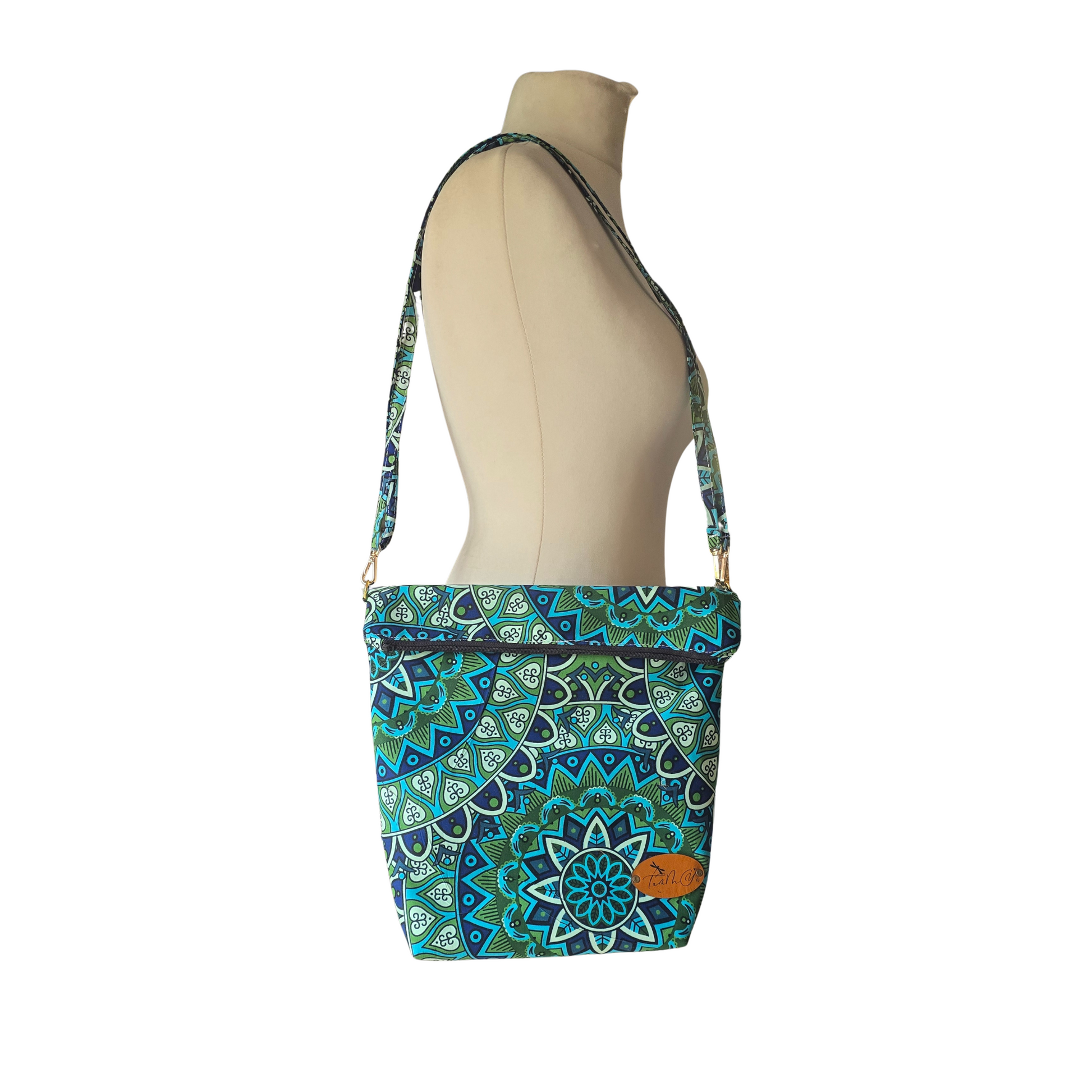 Patterned handbag on a mannequin with a white background
