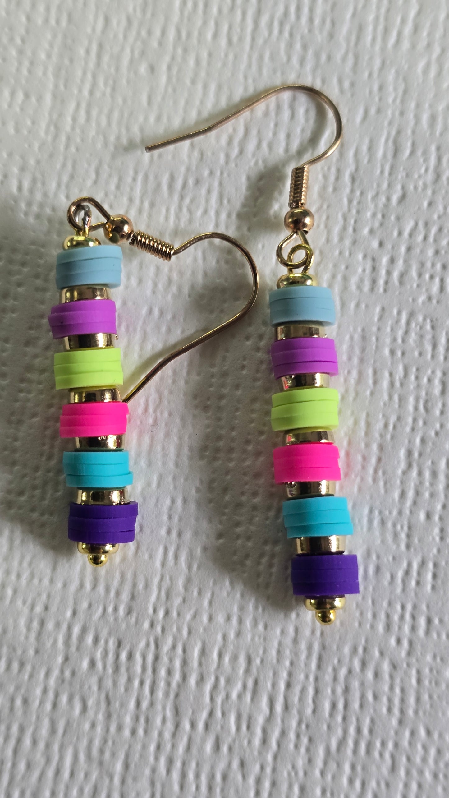 Colorful clay bead earrings on a white background